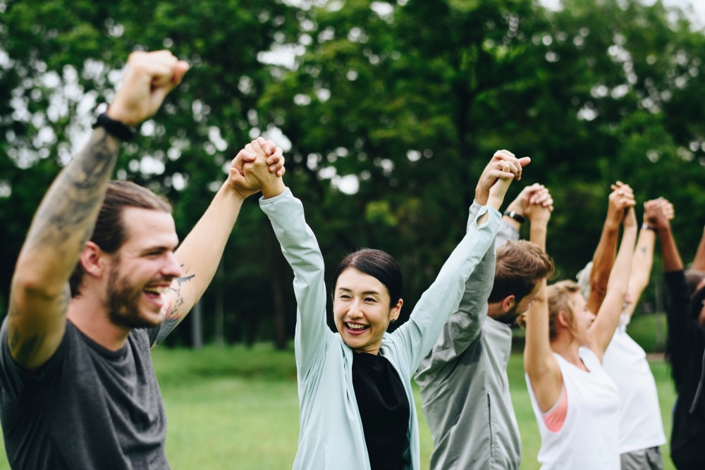 Support group holding hands in recovery